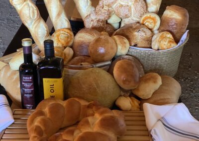 Section of bread bar being set up at farm wedding