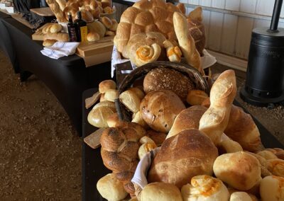 Section of Bread Bar being set up for a farm wedding